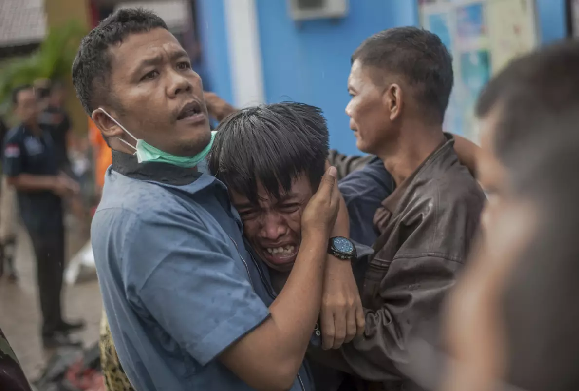 A man reacts after identifying his relative among the bodies of tsunami victims in Carita, Indonesia.