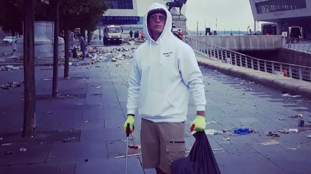 Liverpool Fan Volunteers To Help Clean Up Following The Celebrations