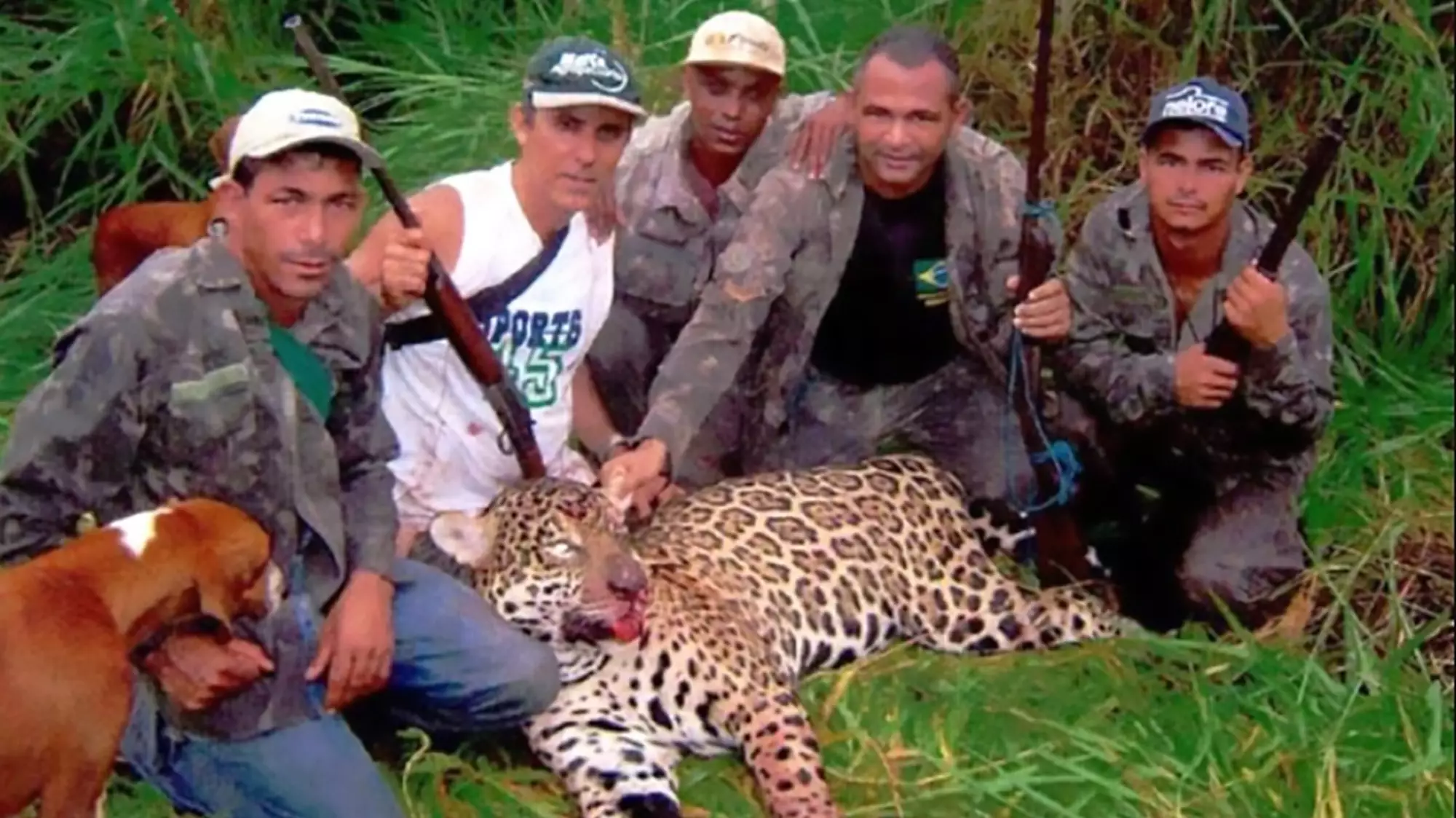 The poachers with a killed jaguar.
