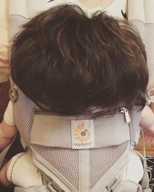 Baby Chanco strapped into her baby carrier.