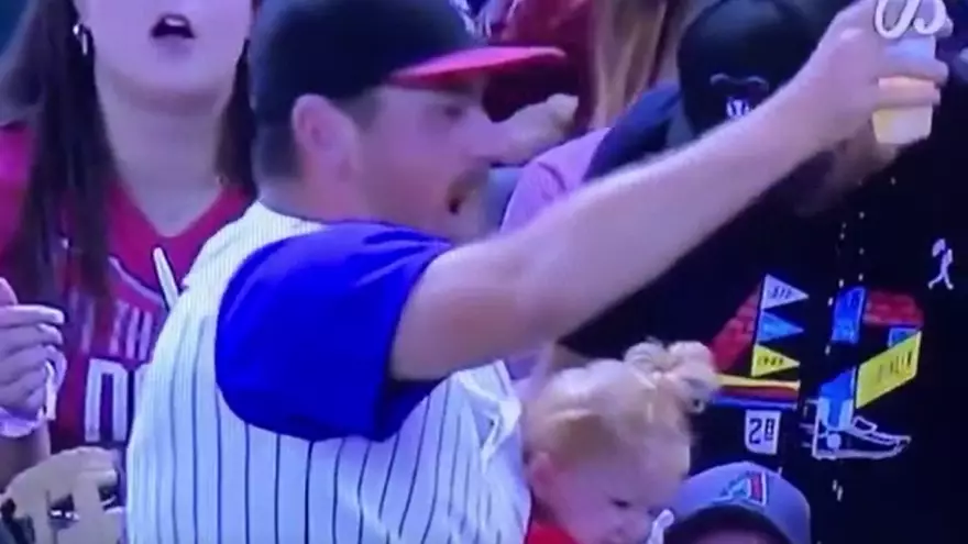 Dad Manages To Juggle His Baby And Beer While Catching Ball At Baseball Game