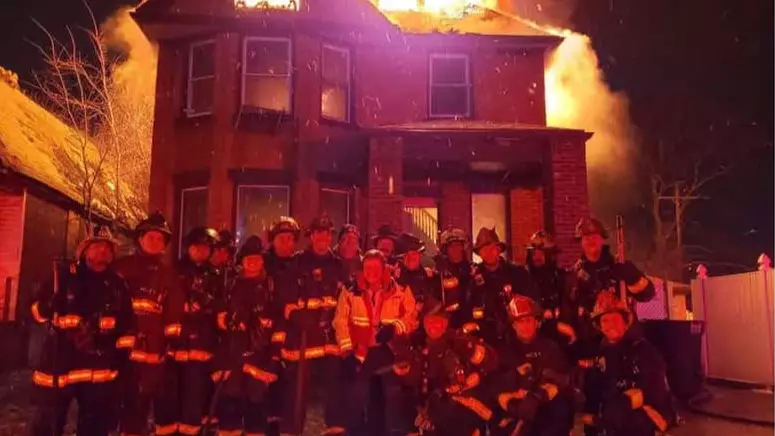 Detroit New Year's Eve Fire Crew Pose In Front Of Burning House 