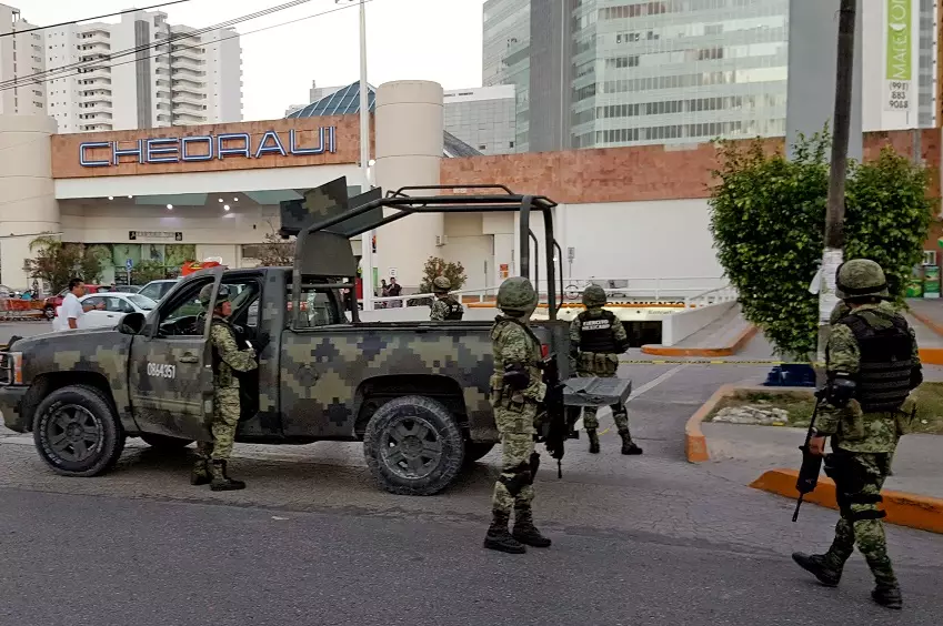Soldiers on guard after an attack in Cancun.