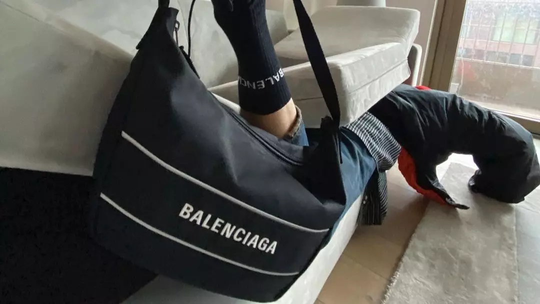 Balenciaga Ridiculed For This Bizarre Bag And Shoe Photoshoot With Model Sandwiched In Sofa