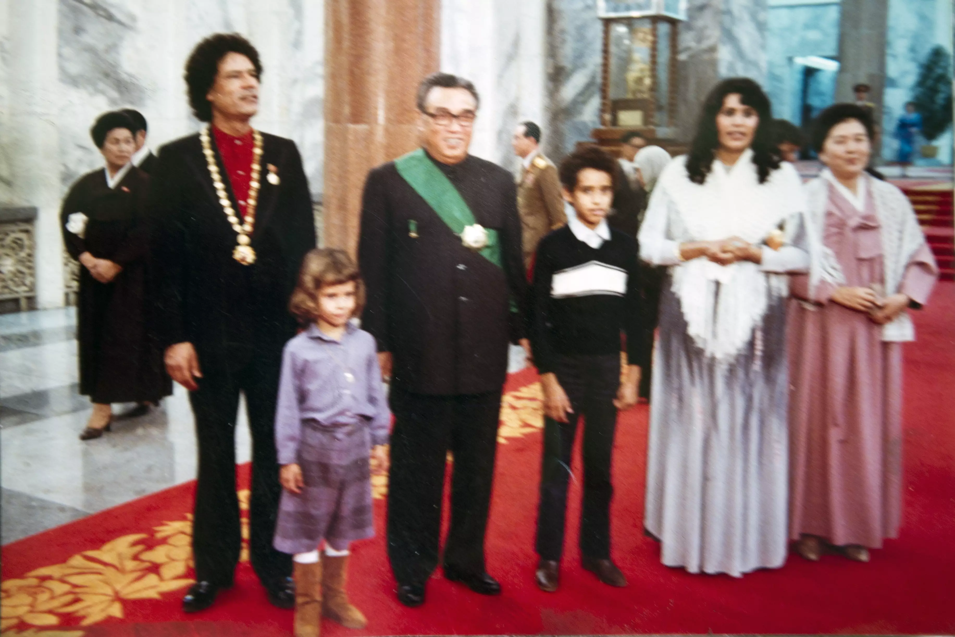 Muammar Gaddafi (L) and his family (children Aisha and Saif El Islam, wife Safiya) posing with the late North Korea leader Kim Il Sung.