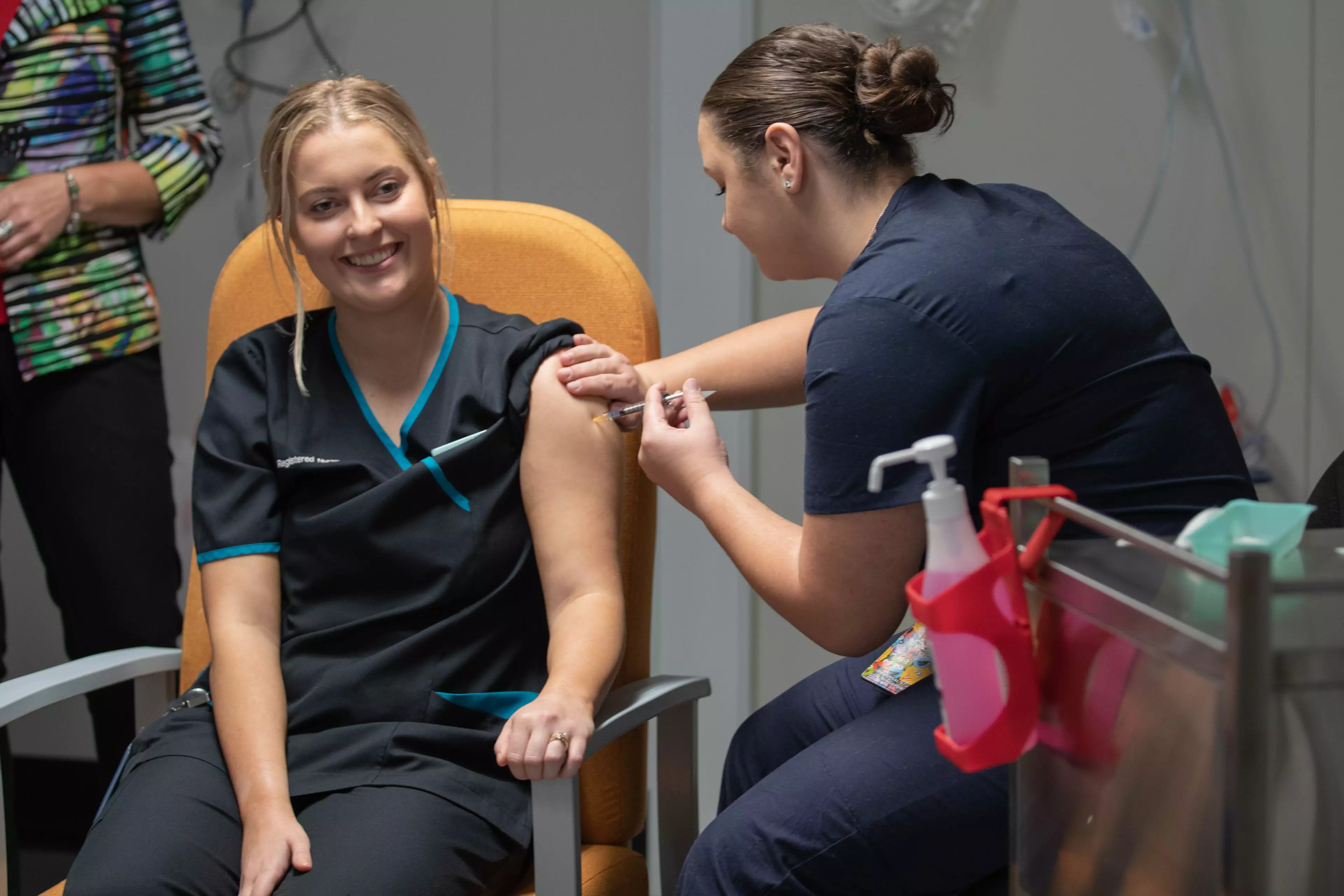 Nurse Maddy Williams receives the Covid-19 vaccine in Canberra.