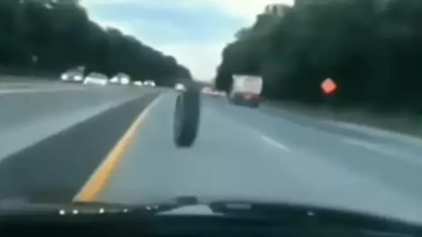 ​Loose Truck Tyre Rolls Down Highway Before Smashing Into Jeep