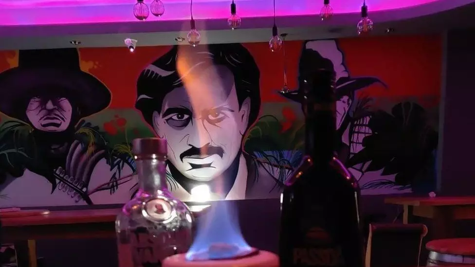 There is a mural inside the bar which appears to depict the drug lord.