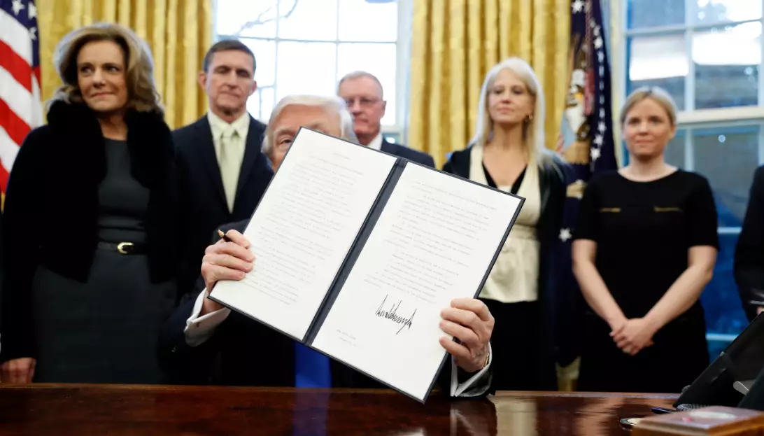 People Love Turning Donald Trump Holding His Executive Orders Into Memes