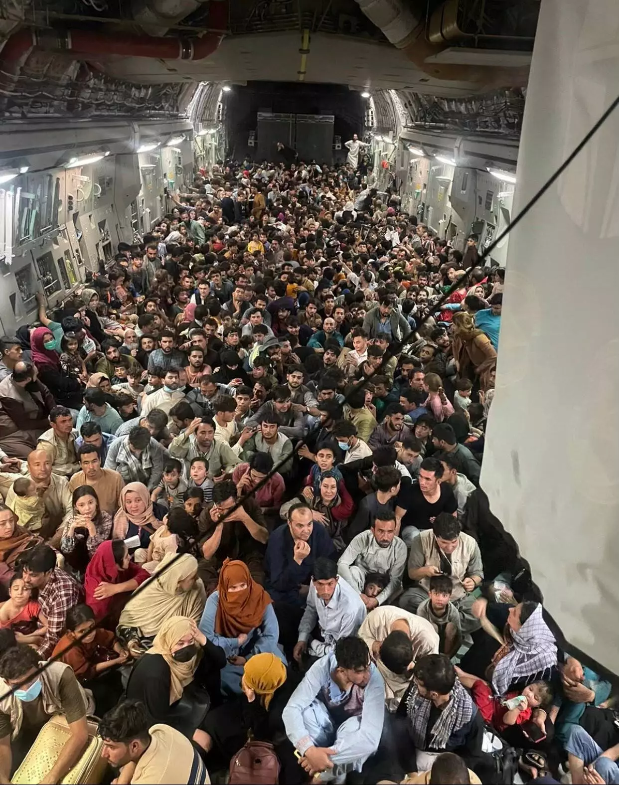 Hundreds of Afghans packed onto a US military cargo plane in a desperate attempt to leave the country (