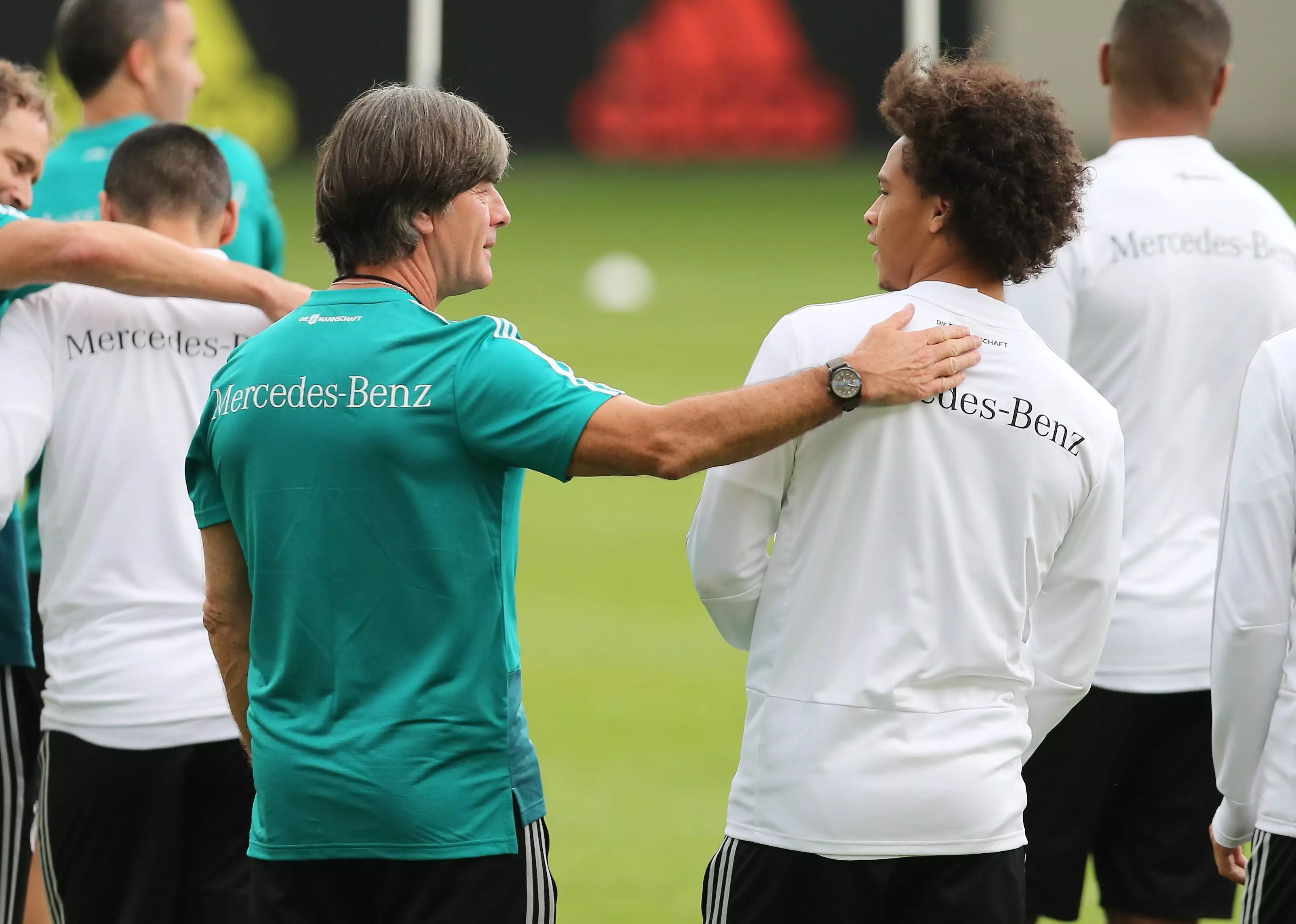 Low chats to Sane on his return to the Germany squad. Image: PA