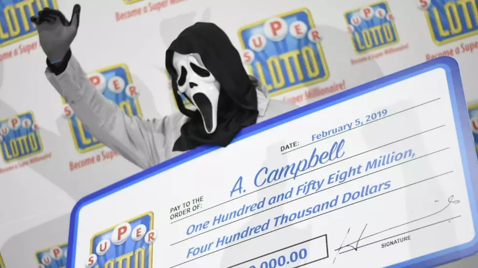 Jamaican Lottery Winner Claims Cheque In Full Scream Costume
