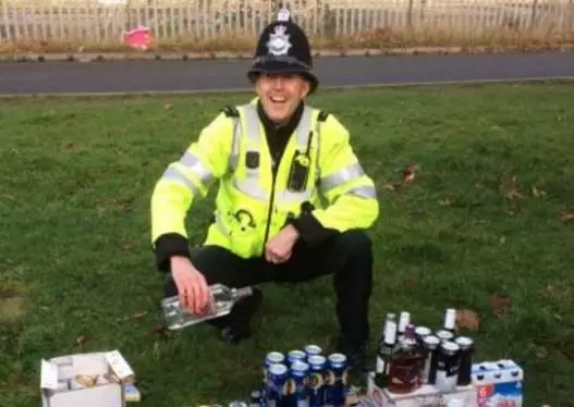 Copper Takes Picture Next To Booze Following Coach Raid