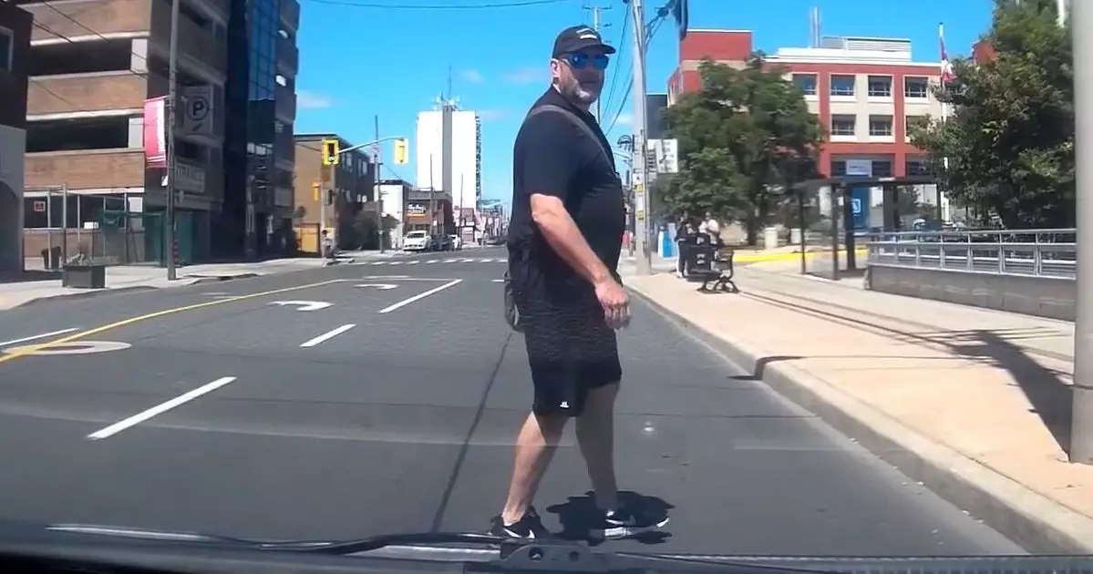 Angry Jaywalker Smashes Into Pole While Staring Out Driver 