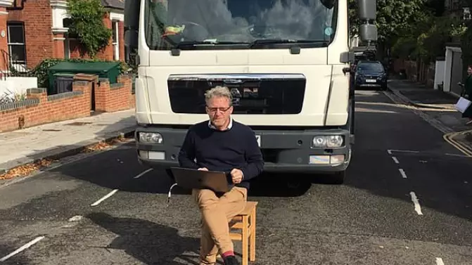Man Sits On Chair In Road To Stop Porsche Being Towed 