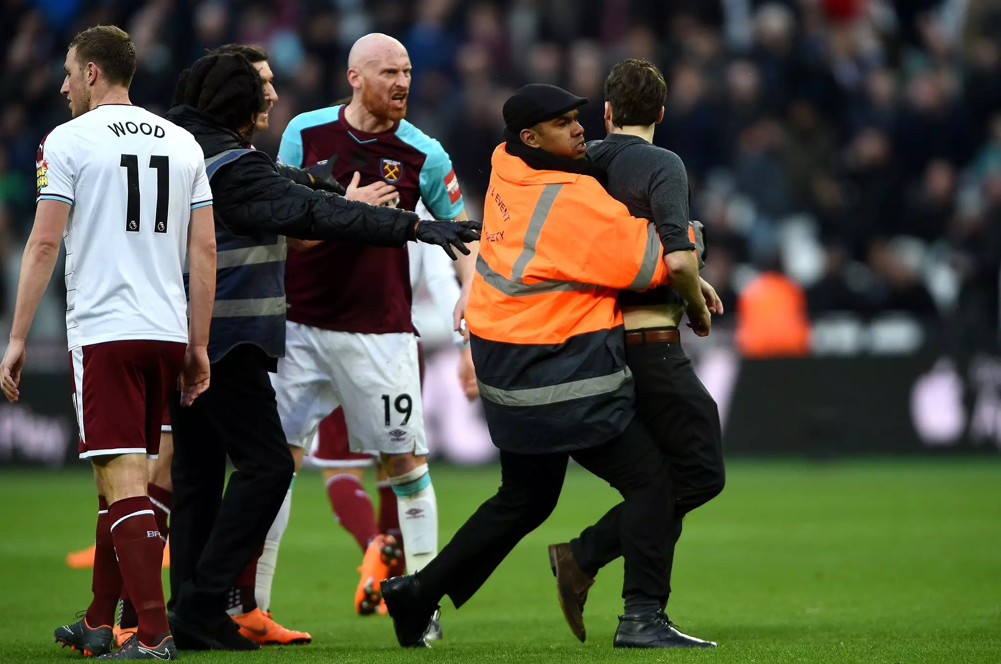 Pitch invader confronts James Collins. Image: PA