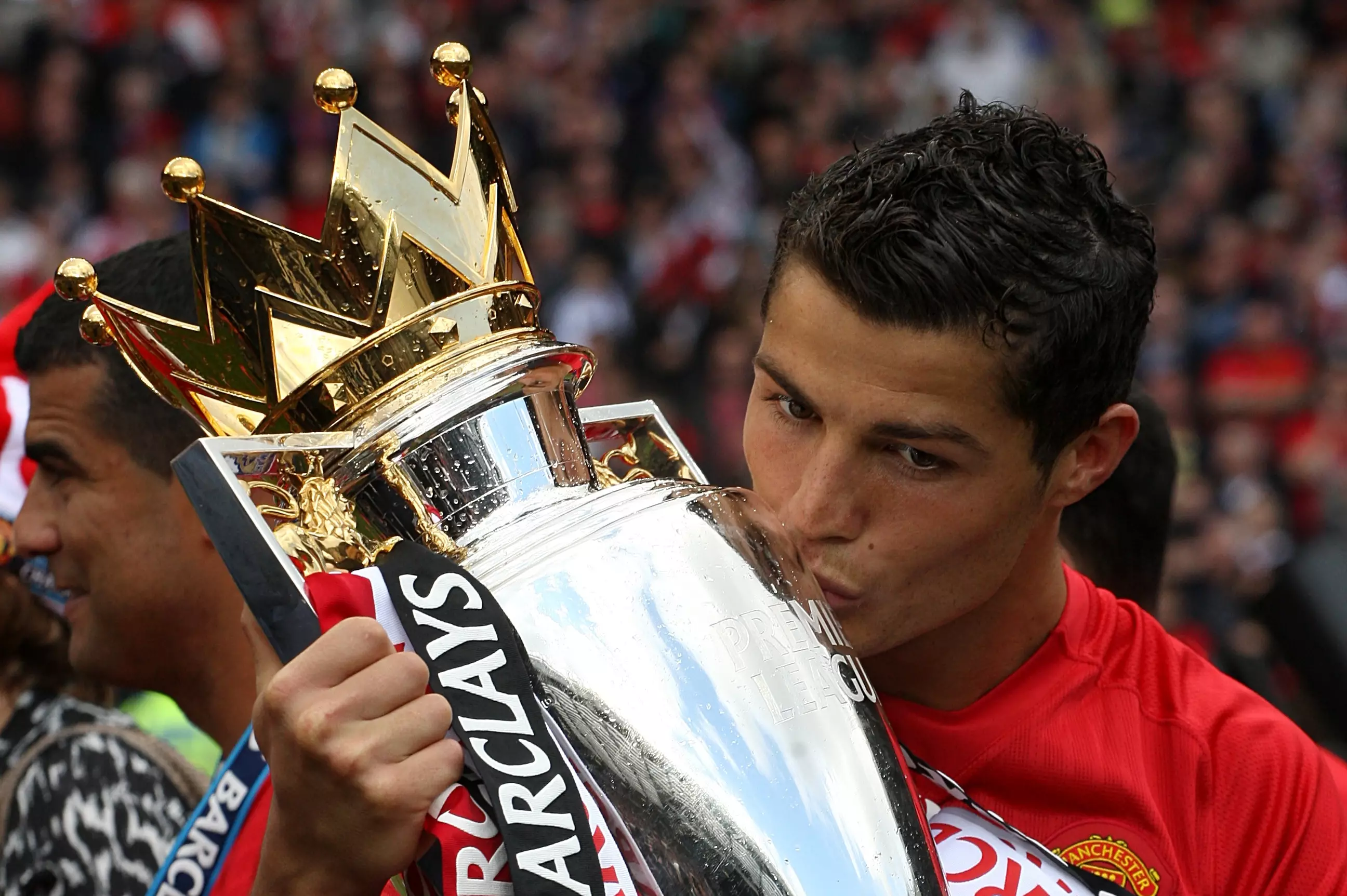 Ronaldo plants a kiss on the Premier League trophy. Image: PA