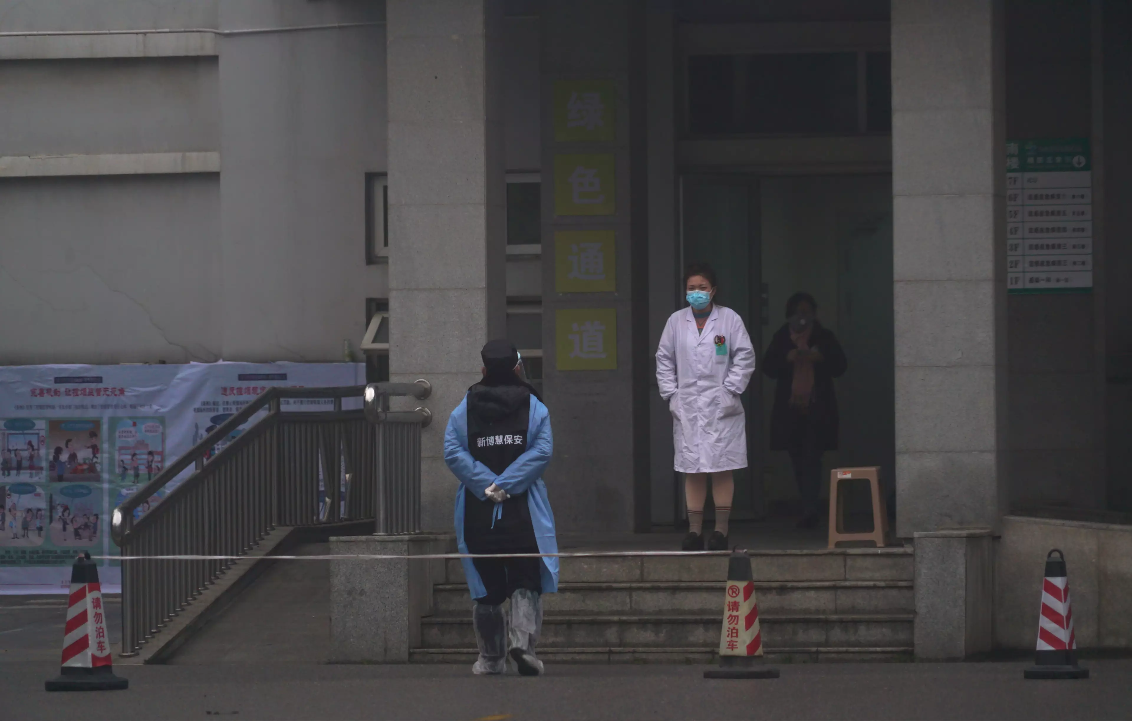 Hospital staff outside the emergency entrance of Wuhan Medical Treatment Center.
