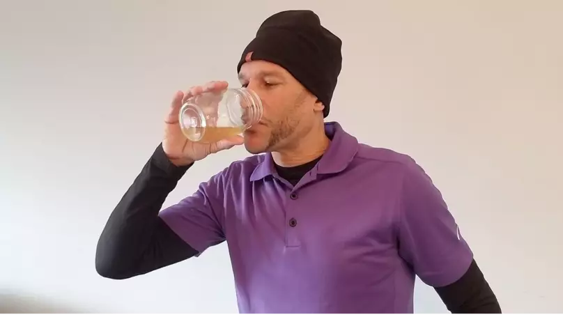 John DePass enjoying a cup of urine.