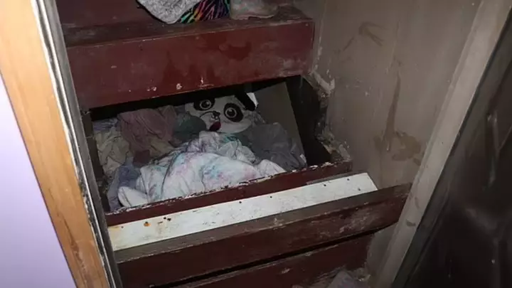 Police located the little girl in a makeshift room under a closed staircase leading to the basement of her grandfather's home.